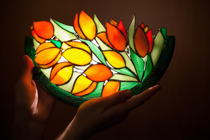 Handmade stained glass lamp with tulips flowers in woman's hands