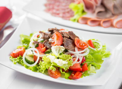 Vegetable salad with beef meat in restaurant