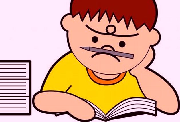 しかめっ面で本を読む子供